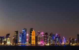 a city skyline with colorful lights